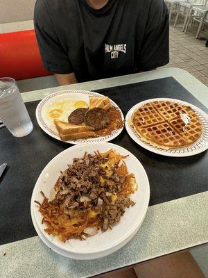 steak hashbrown bowl, waffles, and hot sausage with the toast and sunny side up eggs