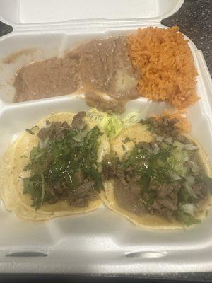 Two asada tacos with rice and beans