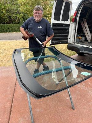 My new car windshield and the man that came out and installed it.