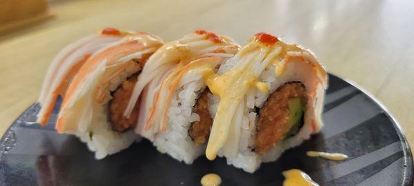 TNT roll - spicy tuna,  avacado, topped with kani, spicy mayo & a dot of Sriracha- Excellent!