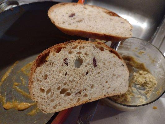 This is the Olive and garlic sourdough bread, scooping up homemade butternut squash and garlic hummus..