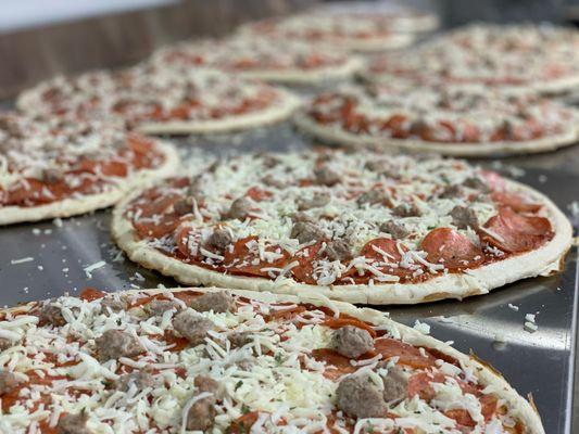 Eau Galle's Own Take-N-Bake Pizzas!  Featuring our Cheddar, Parmesan, Asiago, and Romano.