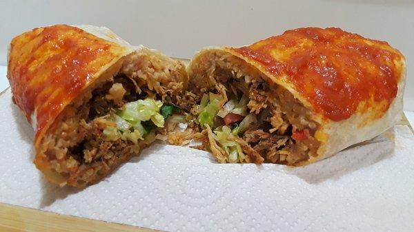 Burrito de Cochinita Pibil: Flour tortilla wrap filled with slow-roasted pork, rice, beans, lettuce, tomato, onion, cilantro