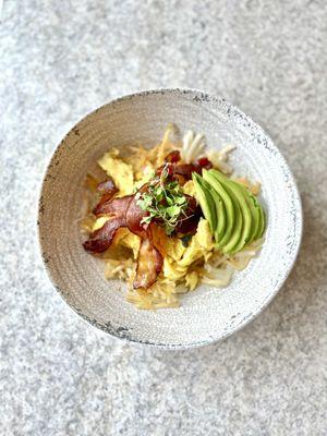 Avocado bacon bowl over crispy hash browns with cheese and your choice of eggs