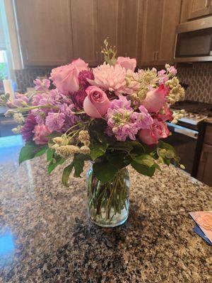 Purple flowers and roses arrangement