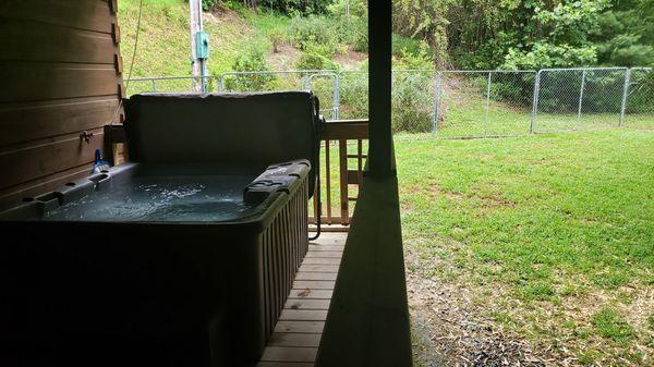 Hot tub and fenced in yard at The Paw Print cabin