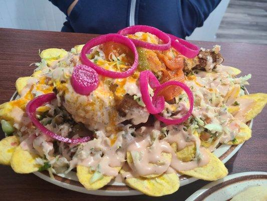 Pollo con Tajadas. Fried chicken over a bed of plantains and slaw.