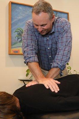 Dr. Bissell performing an adjustment to the midback using the Diversified technique.