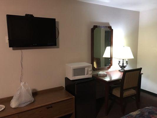 Bedroom includes microwave and a TV