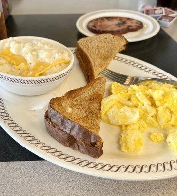 2 Eggs, grits, toast and city ham.  Waffle not pictured