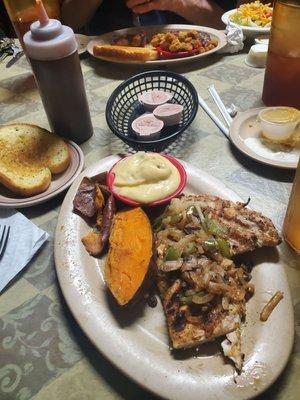 12oz Grilled chicken breast with baked sweet potato, banana pudding, and garlic toast.