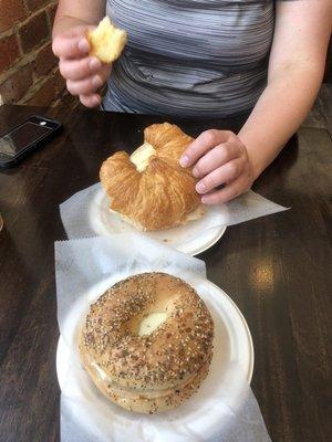 Two turkey egg and cheese breakfast sandwiches. One on an everything bagel and one on a croissant.