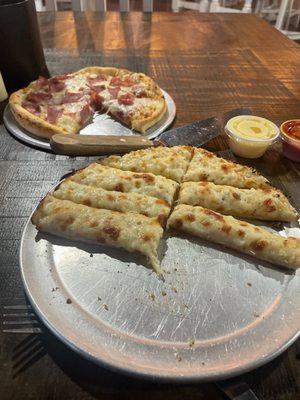 Small ham pizza and cheese sticks.