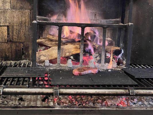 Our steak on the wood fire grill.