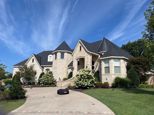 This stunning NWA home proudly displays our classy, and beautiful, "Moire Black" shingle by CertainTeed.