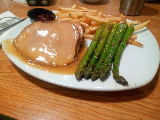 Our Turkey & Dressing is served with your choice of two sides; pictured here with our cooked-to-order fries and the grilled asparagus.