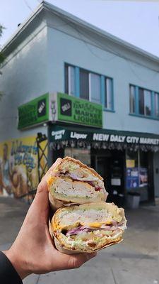 Turkey sandwich on Dutch crunch bread, american cheese, light lettuce, extra onion, with everything except mustard.