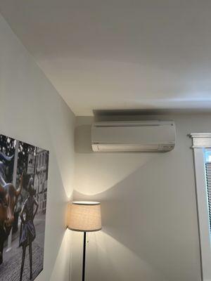 Ductless mini split system indoor unit(brand Daikin)installed in the bedroom.