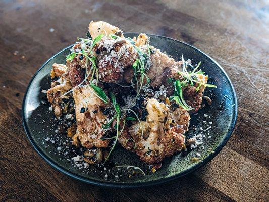 Cauliflower Chilaquiles.  Salsa Verde, cotija cheese, spiced pepita's, furikake, cilantro.