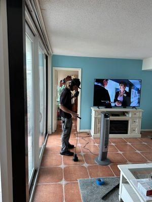 Tyler using out leak detection equipment to locate a leak under a concrete slab in a Clearwater home.