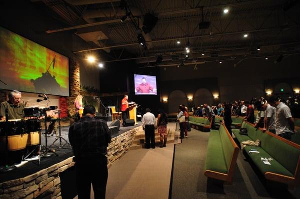 People standing at the altar receiving Christ as their Lord and Saviour