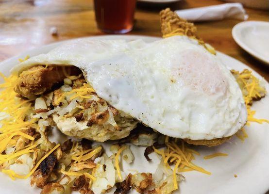 Chicken fried chicken biscuit, covered with hashbrowns and cheese. Topped with fried eggs.