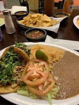 Taco plate with chips and salsa in background