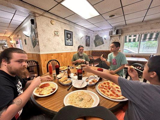 Pizza, pasta, bread, and a family