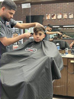 Getting his haircut