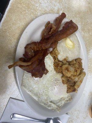 Two eggs over easy, bacon grits, home fries & toast.