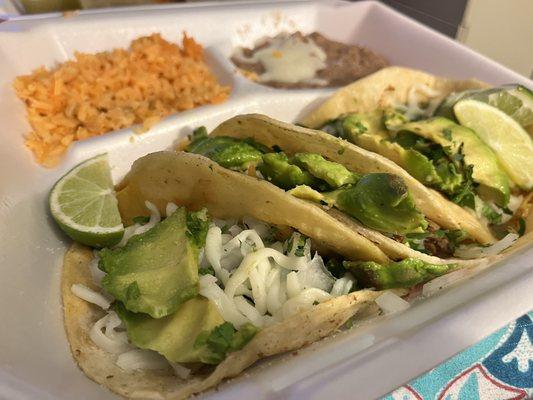 Taco plate.  Barbacoa, shredded beef & shredded chicken with Avocado slices , cilantro, onions, Salsa verde sauce & mozzarella cheese.