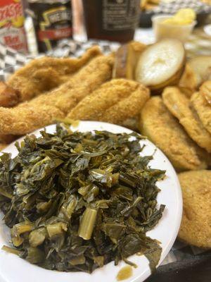 Collard greens and fried green tomatoes as the sides with Catfish