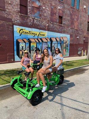 4 buddies enjoying a sunny Cleveland day with drinks on our smaller pedal wagon