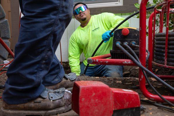 Cleaning a sewer line to prepare for lining