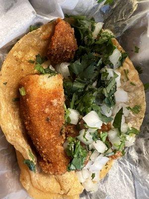 Fish taco with onion and cilantro