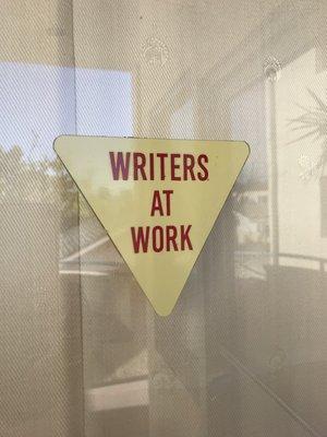 The sign and plant outside entrance windows.