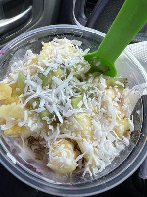 Tropical bowl, topping coconut, pineapples, kiwi and granola.