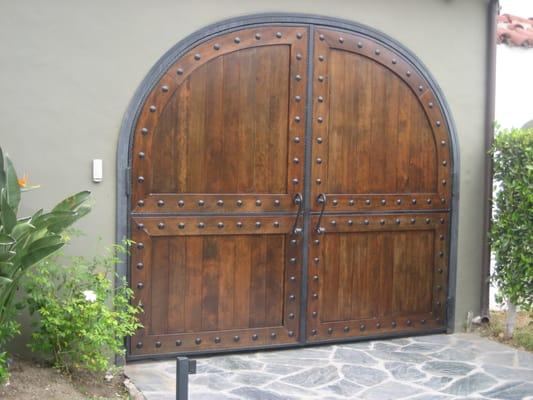 Double swing driveway gate with wood cover in Los Angeles