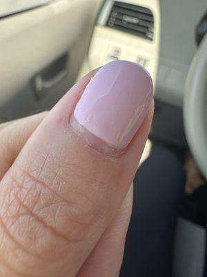 Gel "Manicure" that looks like it's been grown out for 2 weeks. Bubbles, an uneven cuticle and not painted to the cuticle line.