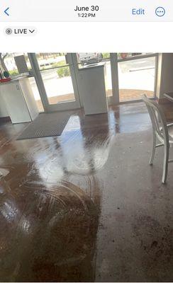 Wet floor inside Shipley's Donuts on Bandera Rd in Helotes. No Wet Floor signs being used.