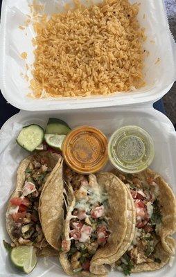 3 chicken tacos with a side of rice