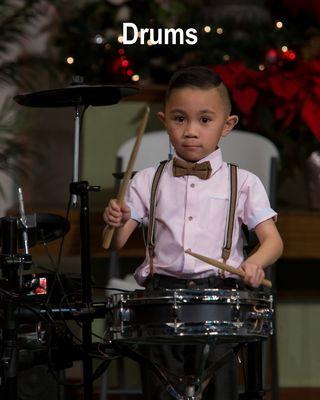 Our little drum student playing his heart out at our winter recital.