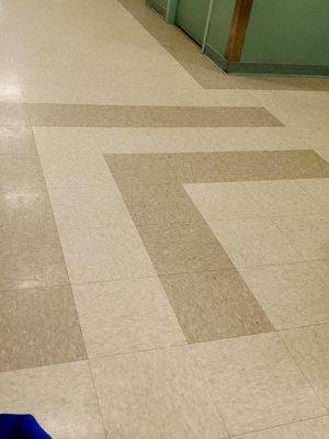 Double "L" pattern in floor tiles. Private joke. They stand for "Lack of care. Lack of caring". UESR standards.