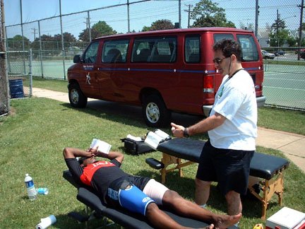 Dr. Charschan treating an athlete on the field