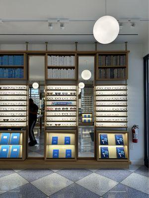 Cute bookcases with books and frames displayed.