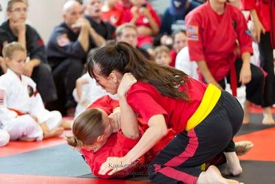 Women in our MMA program grappling during quarterly testing.