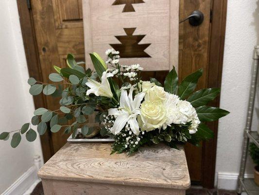 Zen line arrangement w/ roses, lilies, baby's breath, Casablancas, and silver dollars