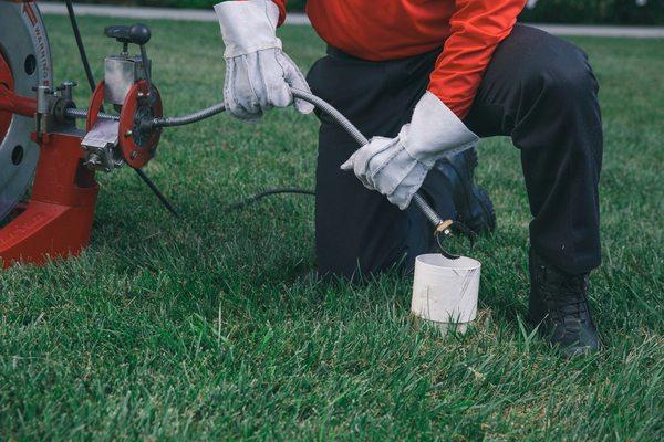 Technician snaking the sewer lines of a customer's home. Snake, sewer, Lines, Drains