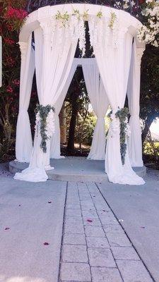 Pillar draping for your ceremony arbor.