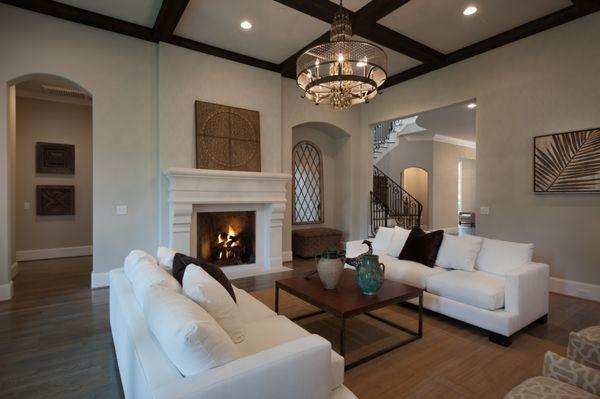 Great room with stone surround and impressive chandelier.